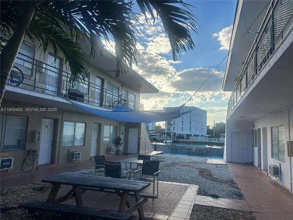 a view of patio with table and chairs and potted plants