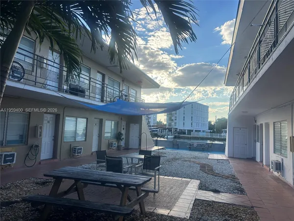 a view of a house with backyard and sitting area