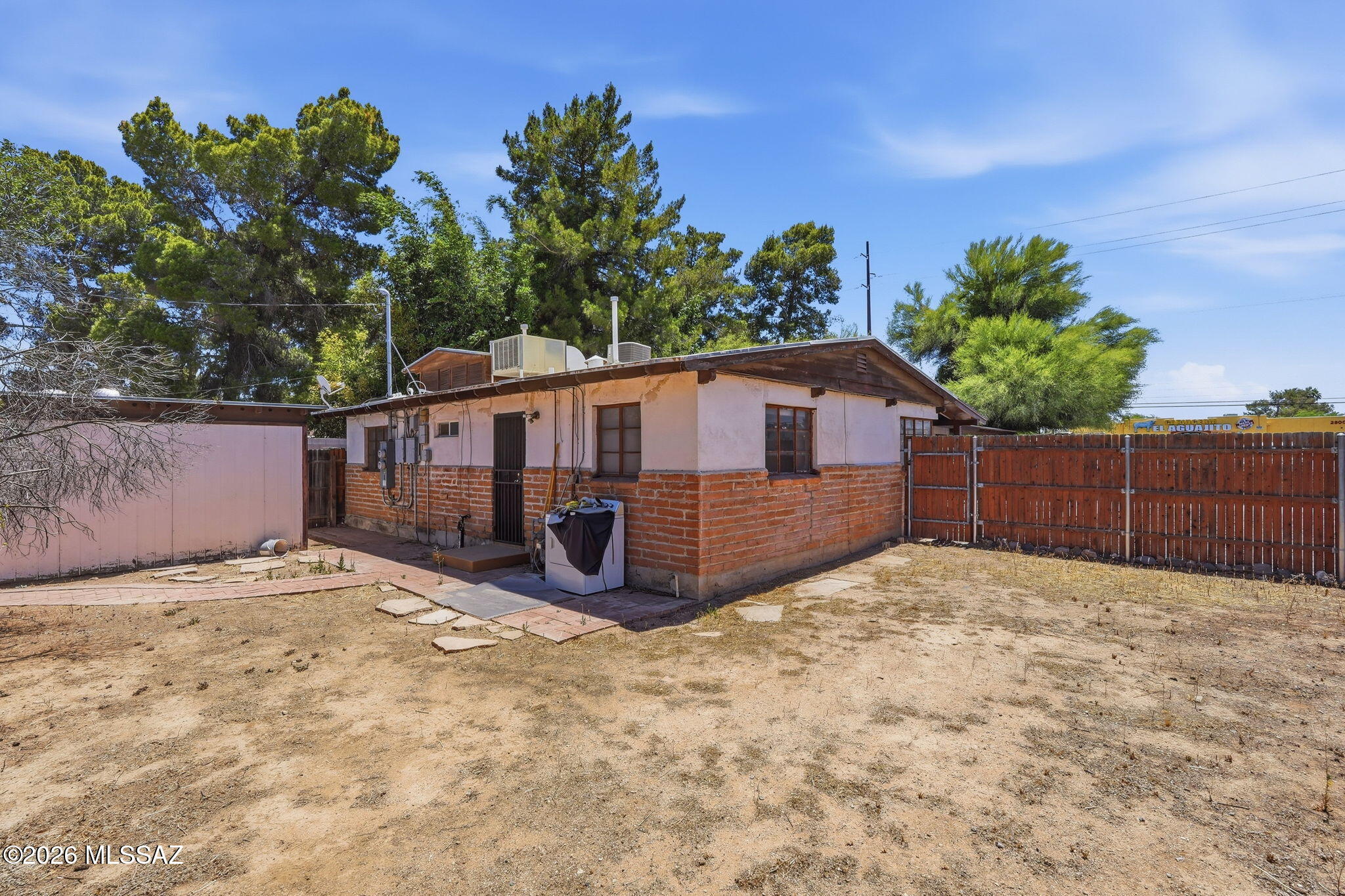 2721 East Fort Lowell Road Tucson, AZ 85716 - Photo 24 of 28 a view of a house with a yard and a wooden fence