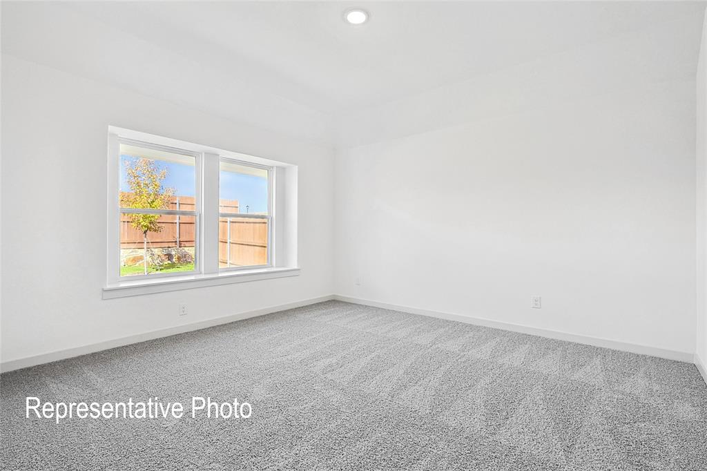2709 Baker Farm Road Forney, TX 75126 - Photo 9 of 10 Spacious room featuring neutral carpeting, white walls, a recessed ceiling light, and a double window with a white frame