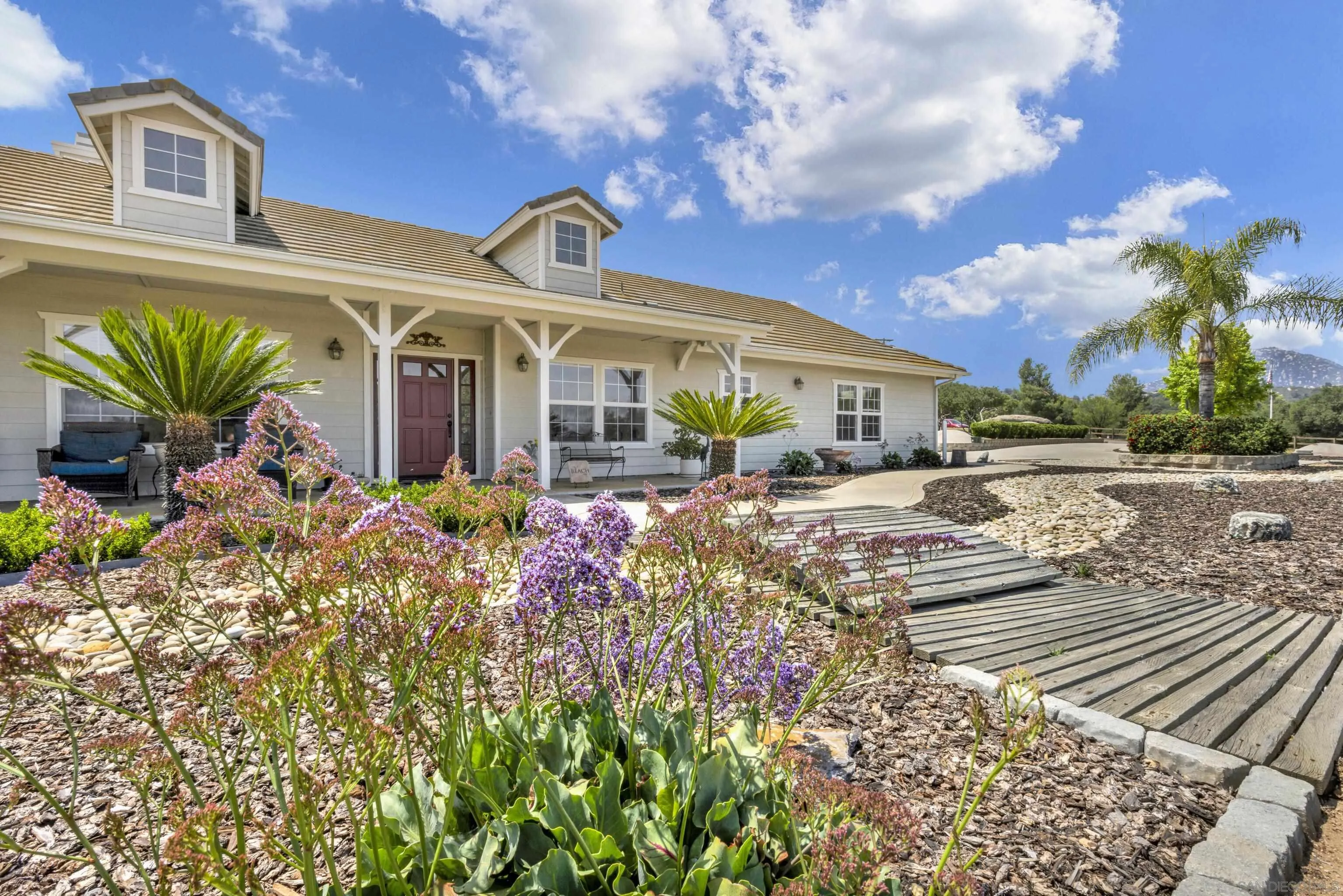 17091 Handlebar Road Ramona, CA 92065 - Photo 8 of 42 a front view of a house with garden