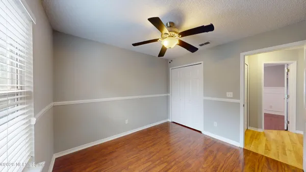 a view of a livingroom with a fireplace wooden floor and a chandelier