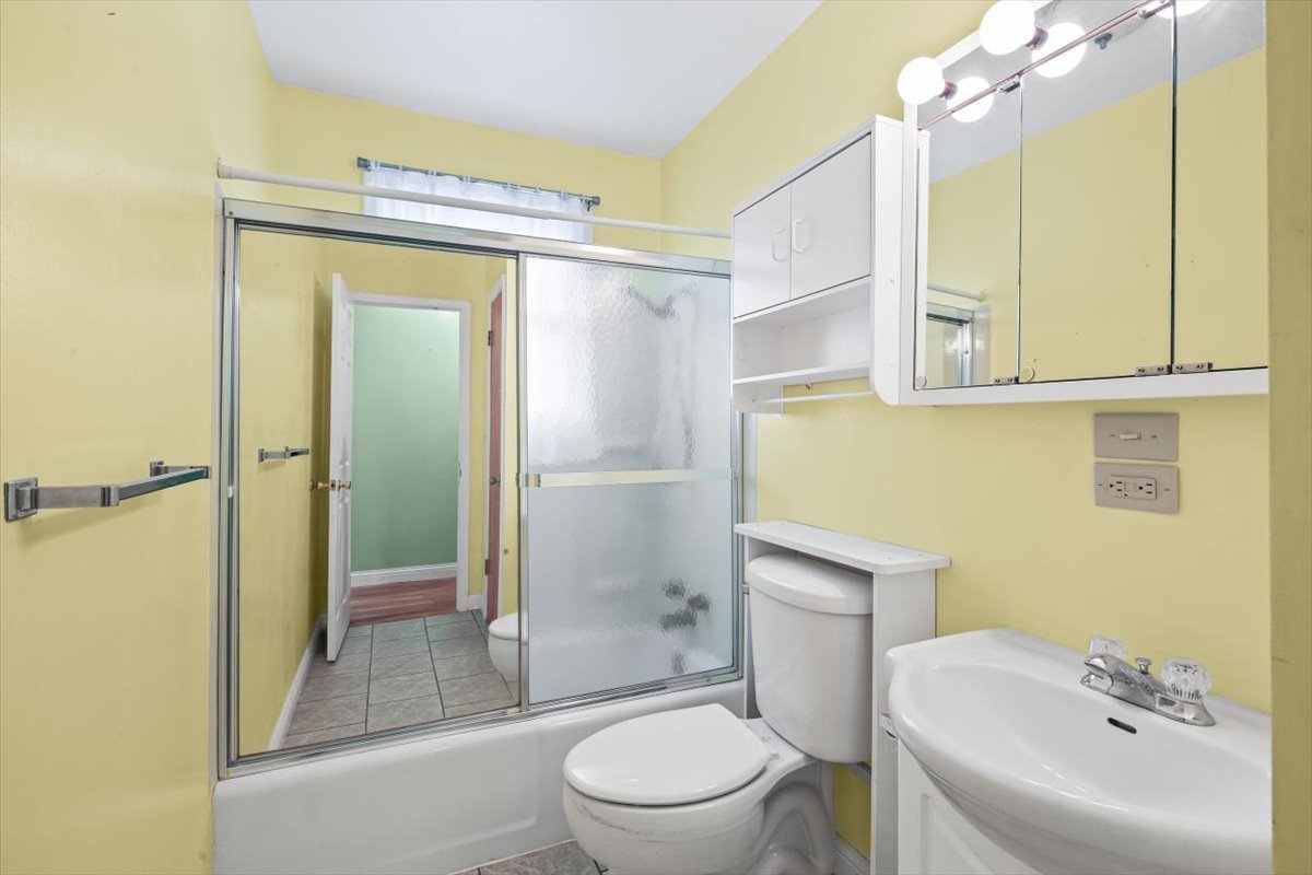 1513 Gates Drive Rantoul, IL 61866 - Photo 19 of 37 a bathroom with a sink a toilet and shower