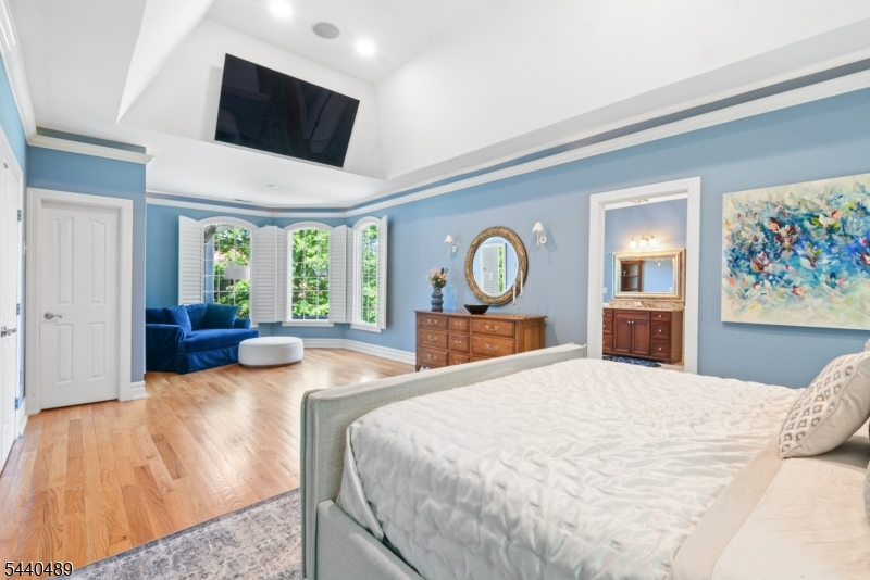 99 East Lindsley Road Cedar Grove, NJ 07009 - Photo 24 of 41 a bedroom with a large bed and flat screen tv