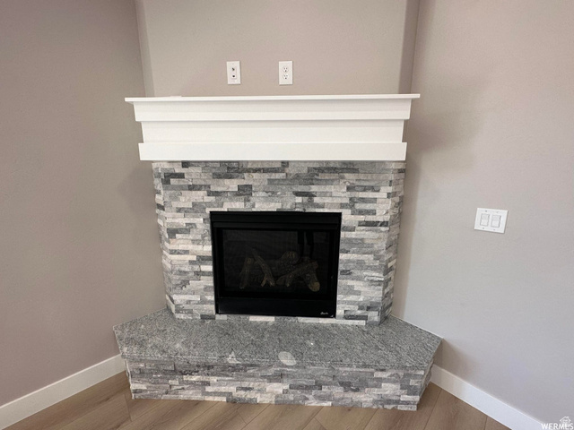 1171 West 2330 North Helper, UT 84526 - Photo 5 of 26 Detailed view of a stone fireplace and wood finished floors