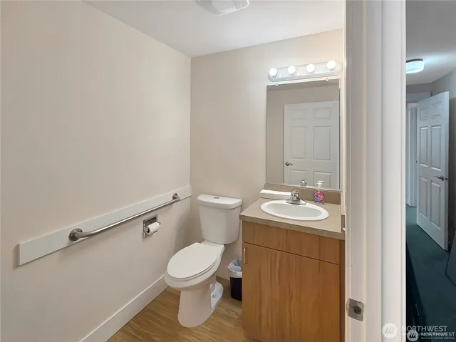 a bathroom with a sink and mirror with toilet