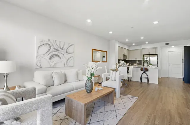 a living room with furniture and a wooden floor