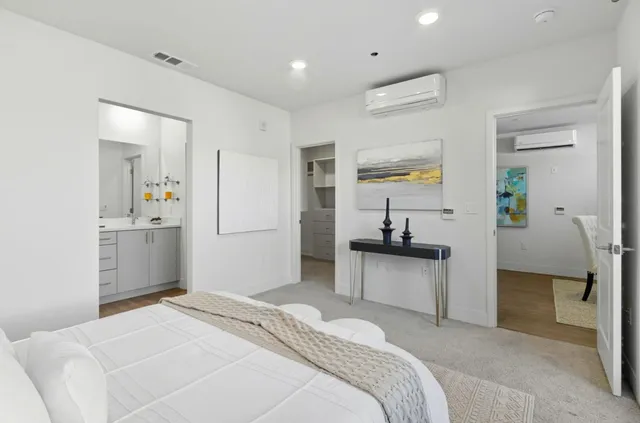 a bedroom with a bed and a view of kitchen