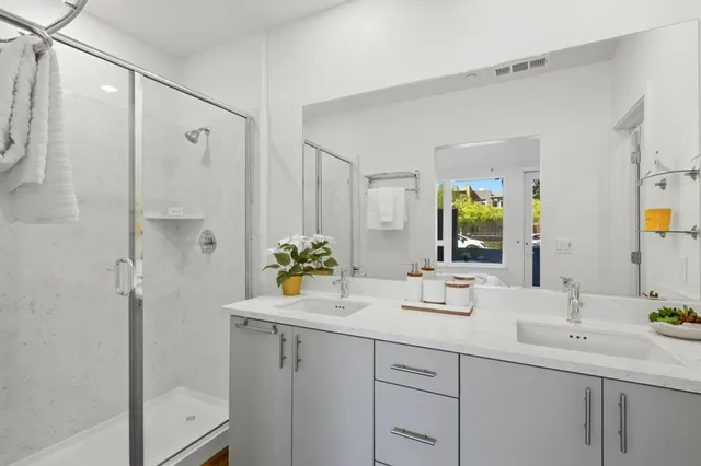 a bathroom with a shower sink and mirror