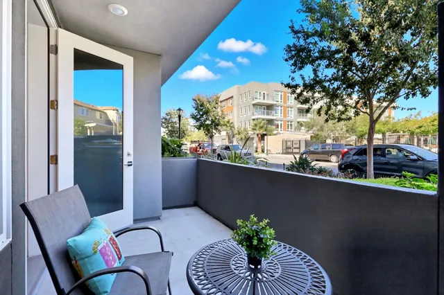 a view of a balcony dining table and chairs