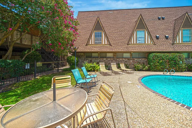 a house with swimming pool in front of it