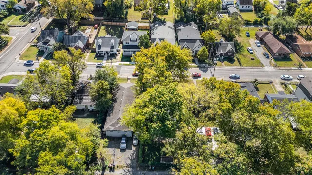 an aerial view of residential houses with outdoor space and street view