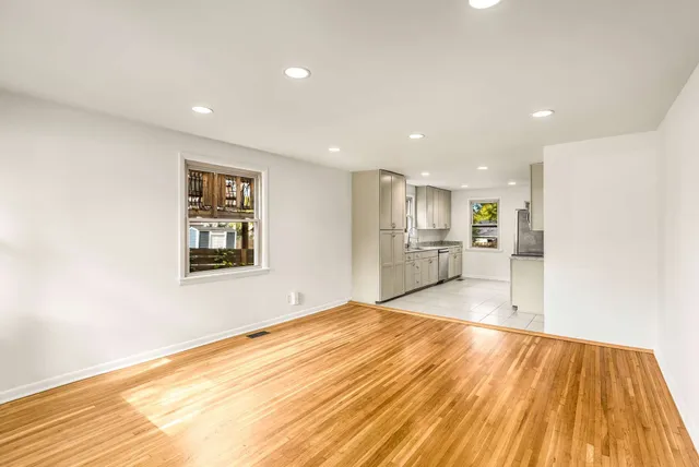 a view of an empty room with wooden floor