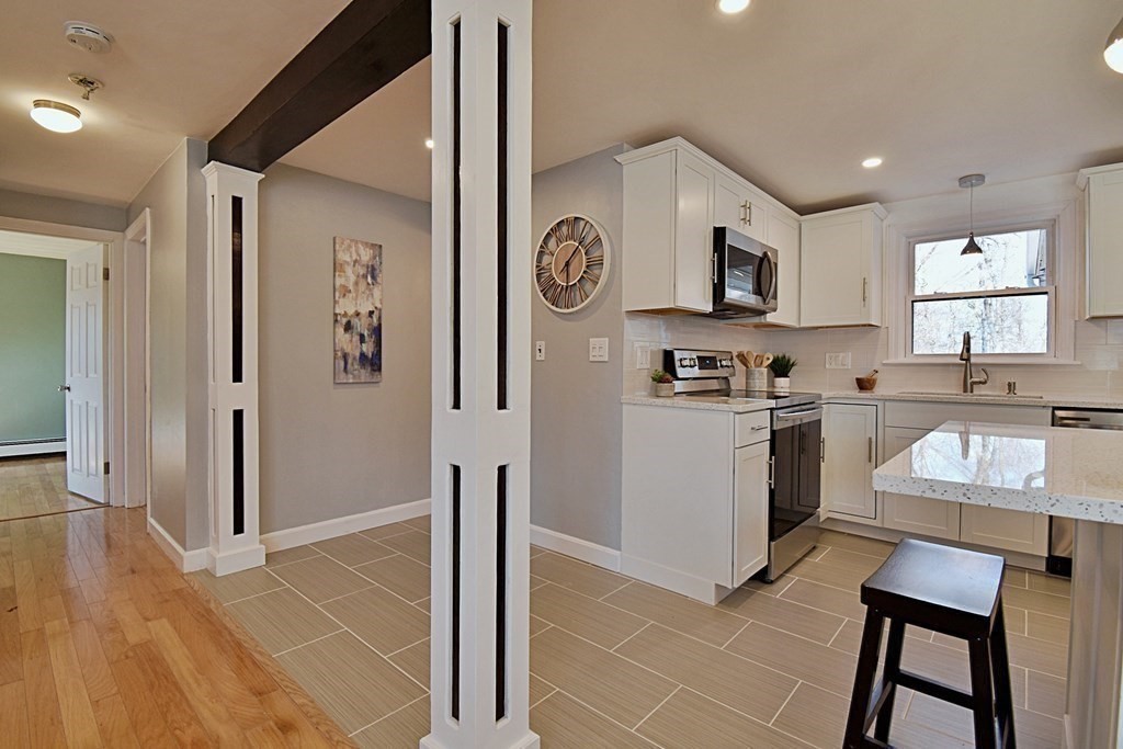 6 Appleton Road Natick, MA 01760 - Photo 6 of 42 a kitchen with stainless steel appliances granite countertop a refrigerator and a stove top oven