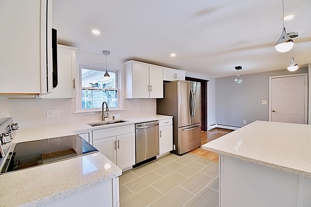 6 Appleton Road Natick, MA 01760 - Photo 10 of 42 a kitchen with a sink a refrigerator and cabinets