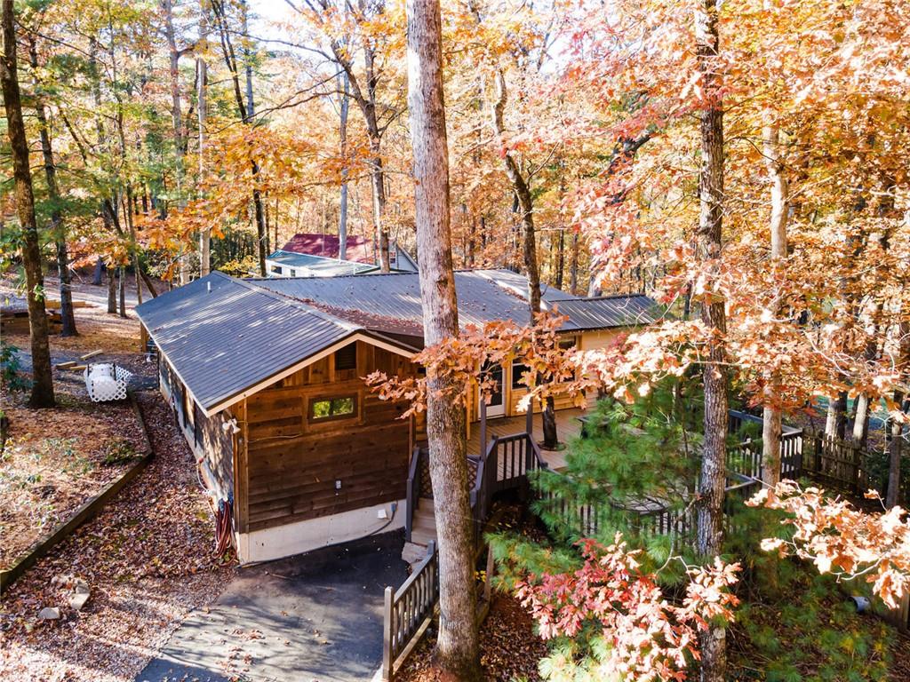 a view of a small space in front of a house with large trees
