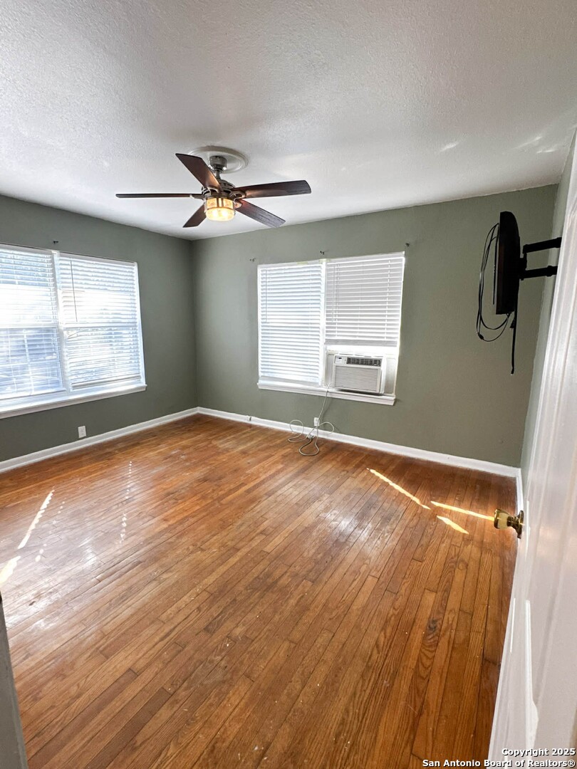 520 West Pyron Avenue San Antonio, TX 78214 - Photo 13 of 19 wooden floor in an empty room with a window