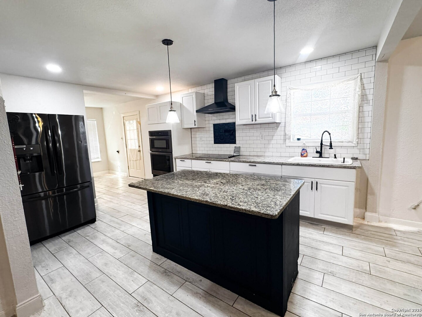 520 West Pyron Avenue San Antonio, TX 78214 - Photo 8 of 19 a kitchen with kitchen island granite countertop a sink and refrigerator