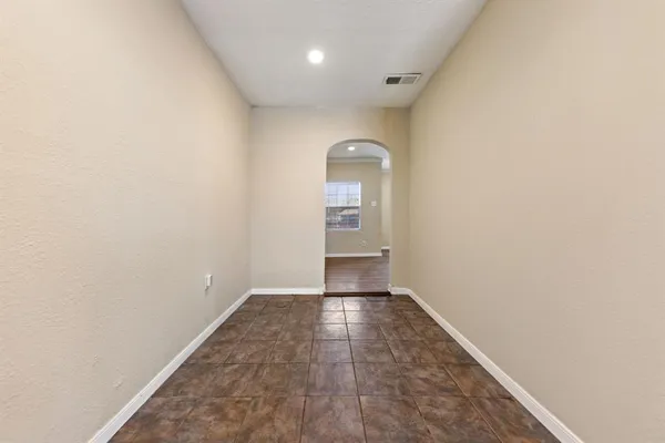 a kitchen with a sink stainless steel appliances and white cabinets
