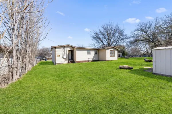 a view of a park with large trees