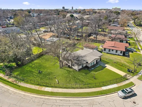 an aerial view of a house with a garden and lake view