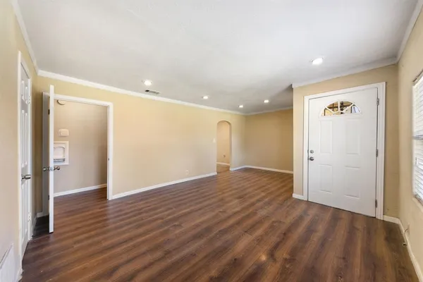 a view of empty room with wooden floor