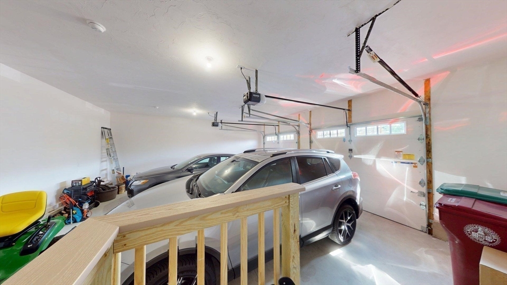 287 Wareham Street Middleboro, MA 02346 - Photo 23 of 28 a bedroom with a bed and a chandelier