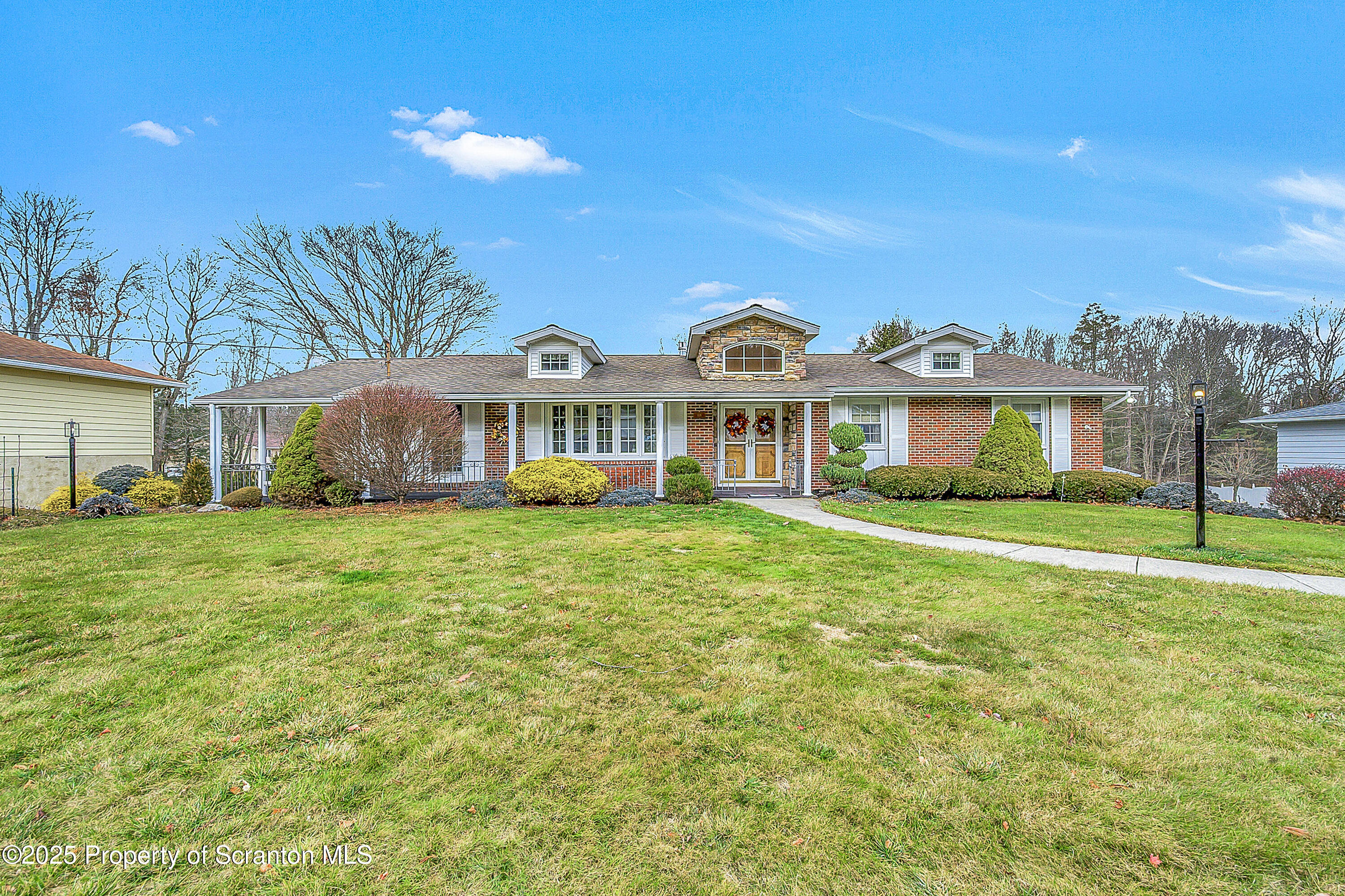 a front view of a house with a garden