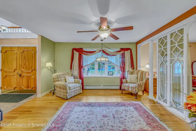 a view of a room with furniture wooden floor and a chandelier