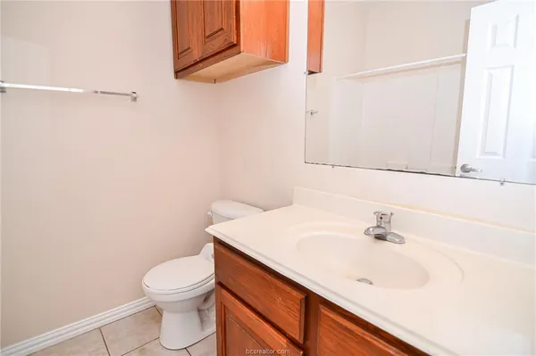 a bathroom with a sink a toilet and vanity