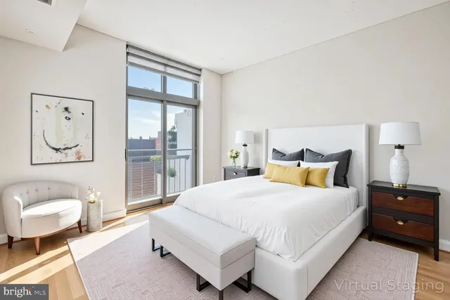 a spacious bedroom with a bed and glass window