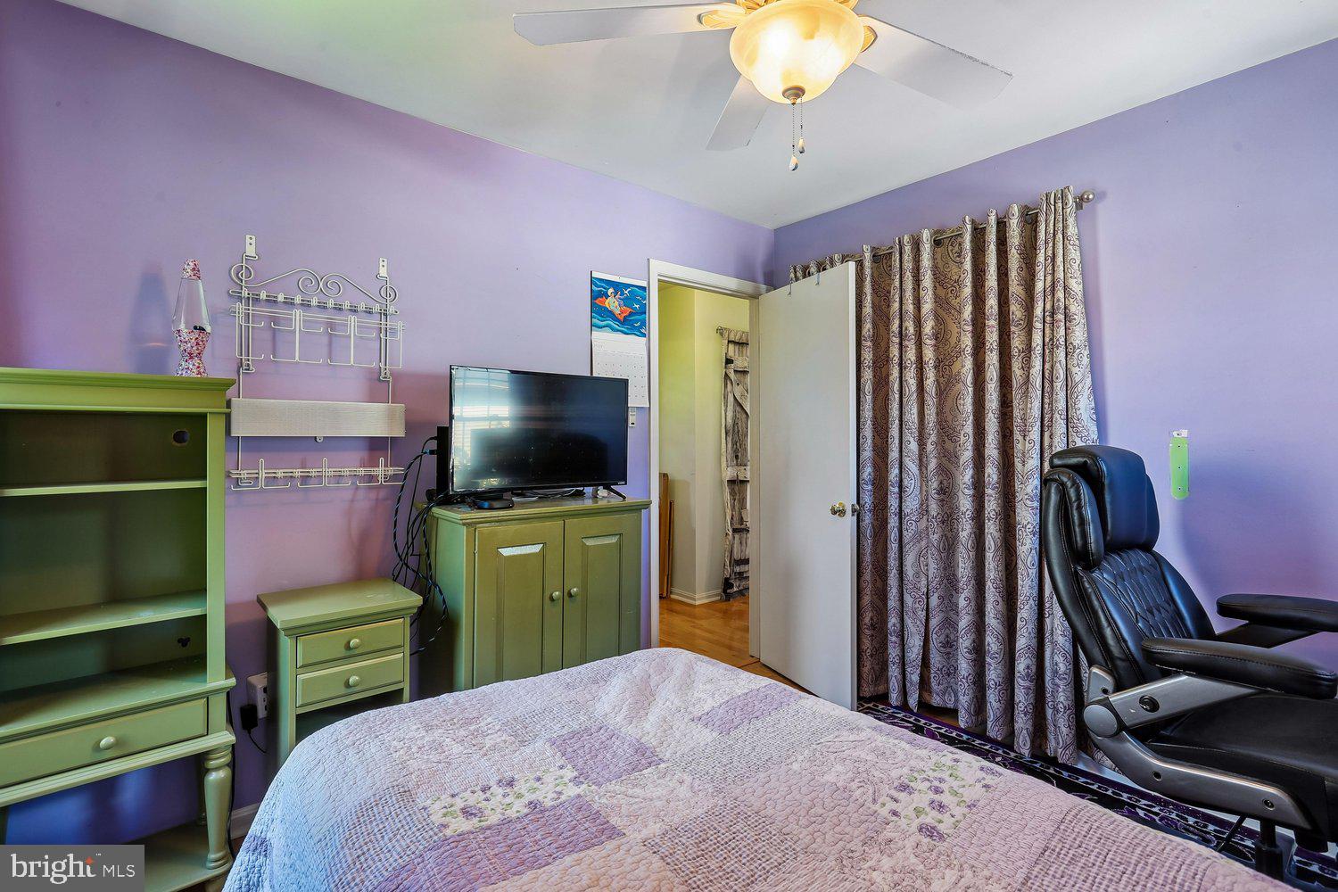 14822 Rose Trellis Place Silver Spring, MD 20906 - Photo 37 of 65 a bedroom with a bed and a television