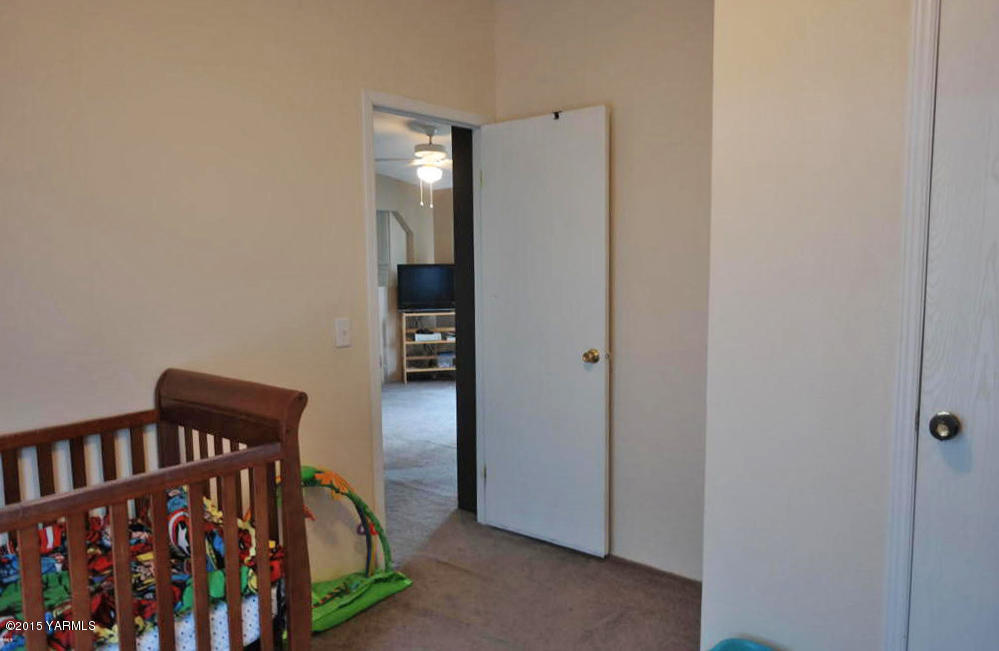 2013 Outlook Road Outlook, WA 98938 - Photo 12 of 18 a view of a bedroom with baby crib and wooden floor
