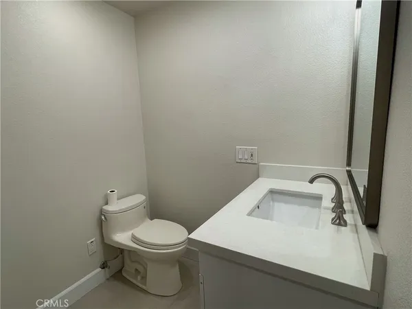 a view of a kitchen with sink microwave and cabinets