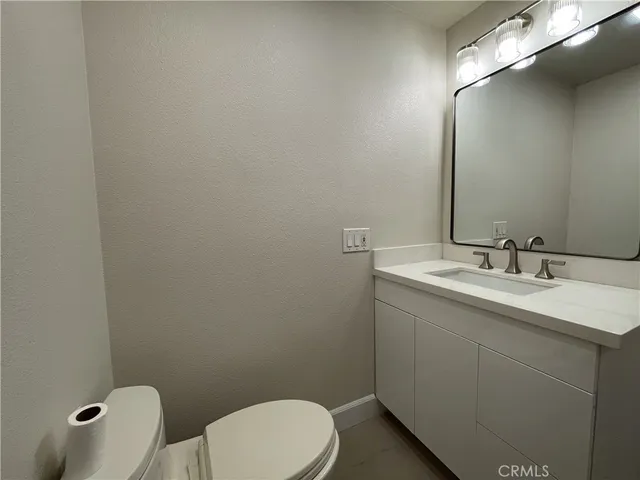 a kitchen with stainless steel appliances a refrigerator and a wooden floor