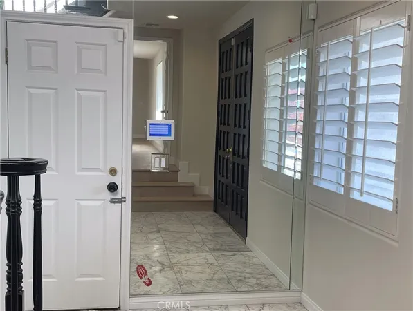 a large white kitchen with a sink and dishwasher a stove top oven with wooden floor