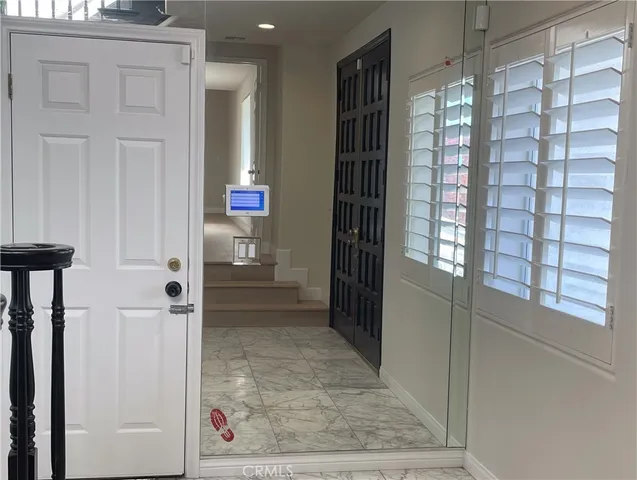 a large white kitchen with a sink and dishwasher a stove top oven with wooden floor