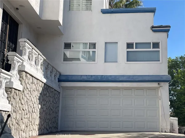 a front view of a house with a blue gate
