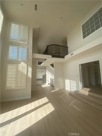 an empty room with a empty space and windows