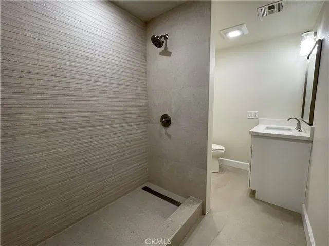 a bathroom with a sink mirror vanity and toilet
