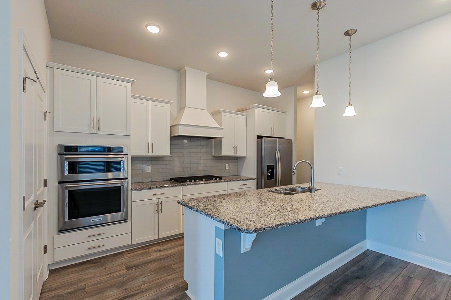 1001 Lonergan Circle Spring Hill, TN 37174 - Photo 6 of 38 a kitchen with kitchen island a sink stainless steel appliances and white cabinets