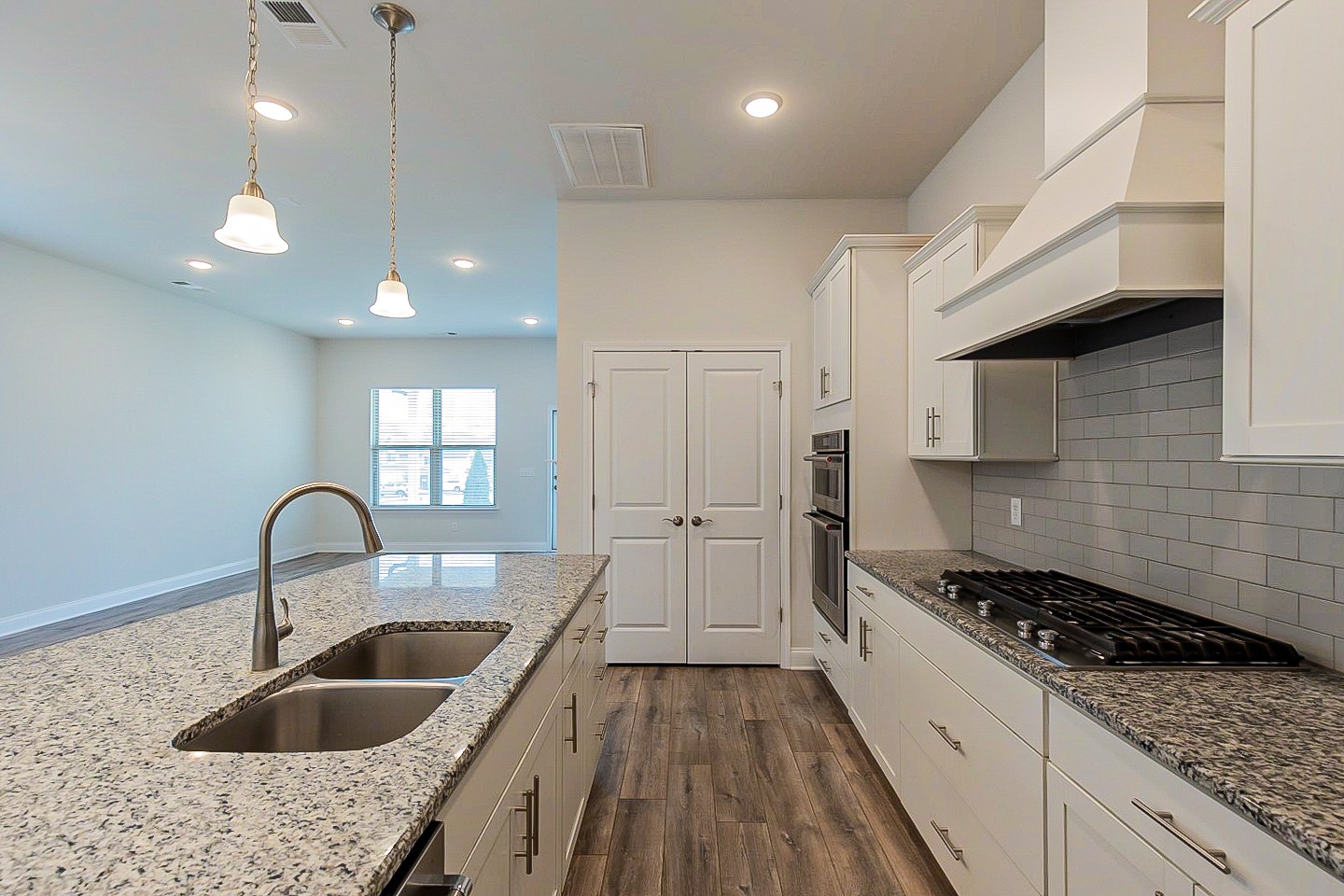 1001 Lonergan Circle Spring Hill, TN 37174 - Photo 8 of 38 a kitchen with kitchen island granite countertop a sink a counter space and cabinets