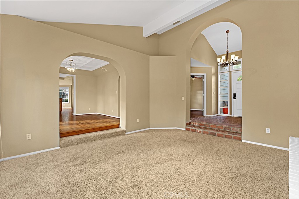 1011 Farrand Court Fallbrook, CA 92028 - Photo 15 of 49 a view of a livingroom with wooden floor and a large mirror