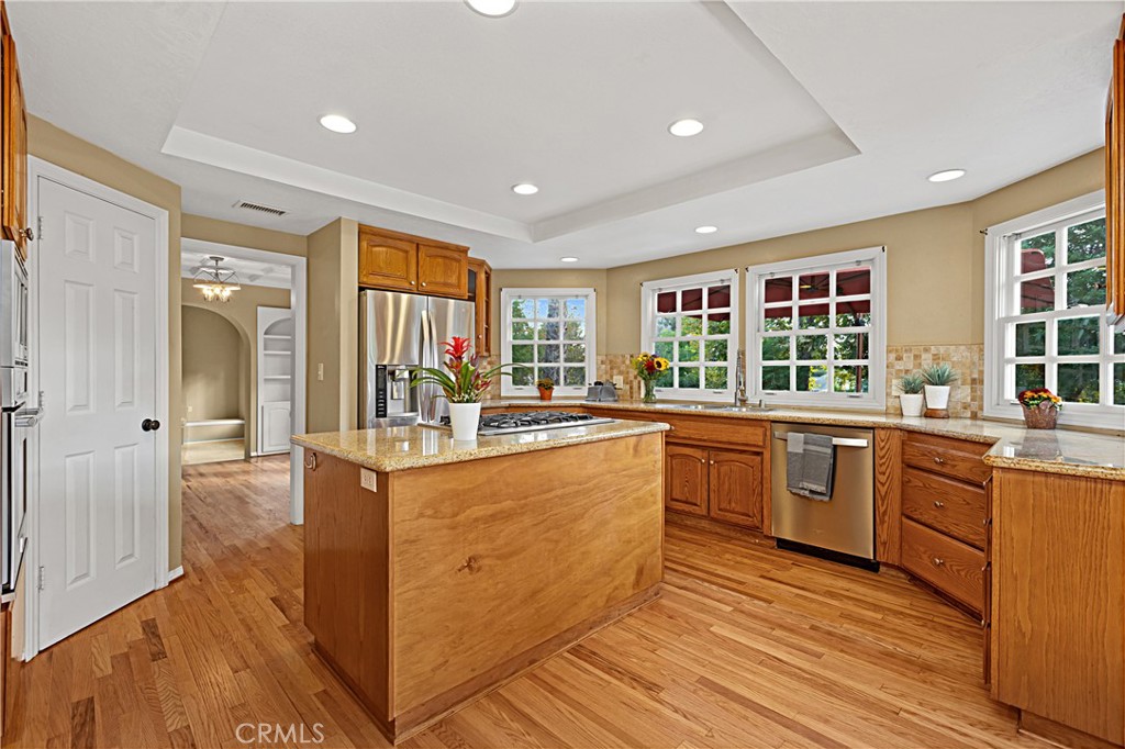 1011 Farrand Court Fallbrook, CA 92028 - Photo 20 of 49 a kitchen with stainless steel appliances granite countertop wooden cabinets a sink and a large window