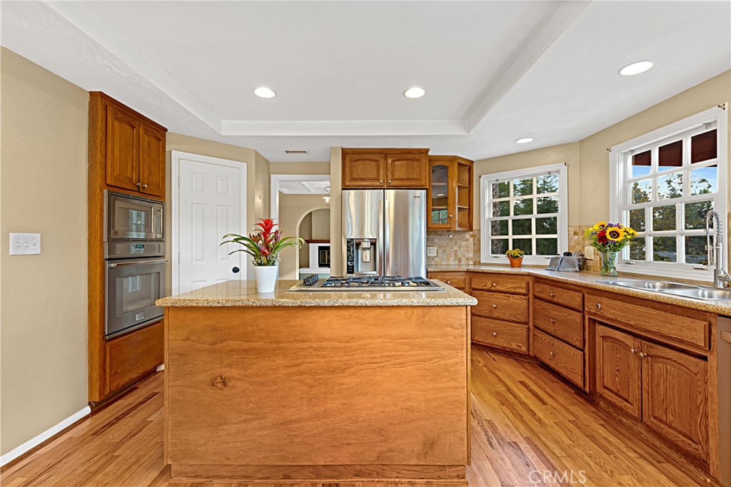 1011 Farrand Court Fallbrook, CA 92028 - Photo 21 of 49 a large white kitchen with kitchen island granite countertop a large window and stainless steel appliances