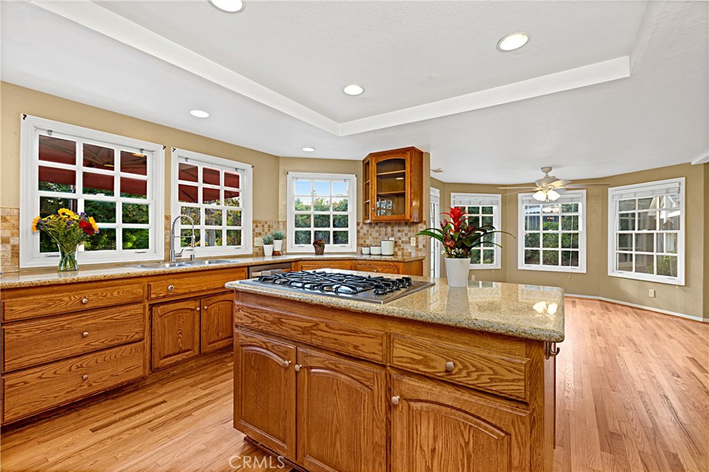 1011 Farrand Court Fallbrook, CA 92028 - Photo 22 of 49 a kitchen with granite countertop wooden cabinets and a wooden floor