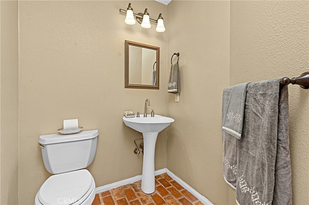 1011 Farrand Court Fallbrook, CA 92028 - Photo 28 of 49 a bathroom with a toilet sink and mirror