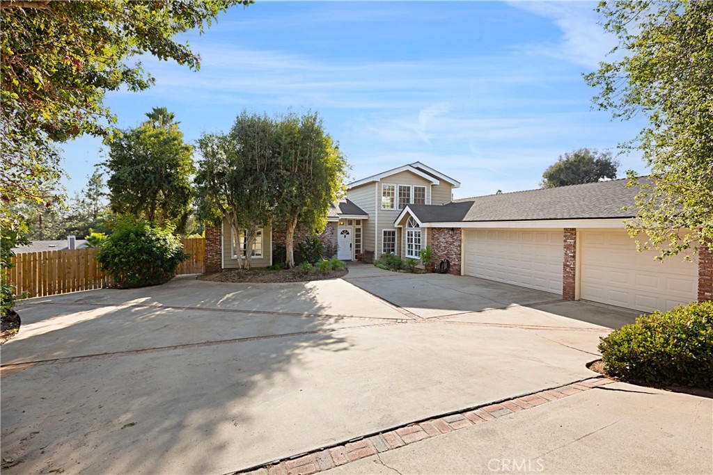 1011 Farrand Court Fallbrook, CA 92028 - Photo 3 of 49 a front view of a house with a yard and garage
