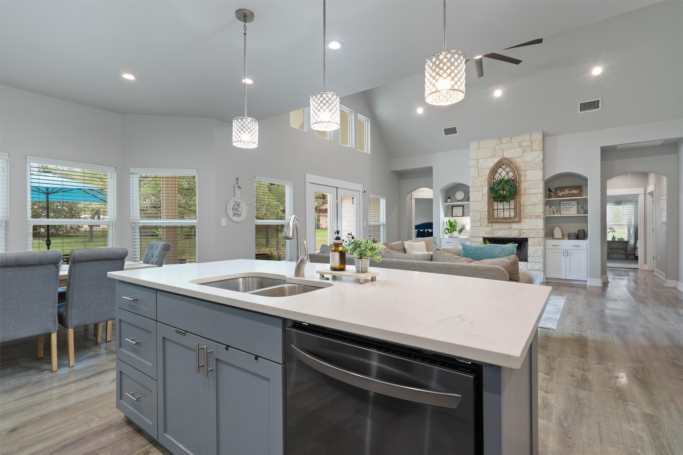 13105 Rooster Springs Road Austin, TX 78737 - Photo 7 of 38 The property features an open concept kitchen and living area with a kitchen island, recessed lighting, and a stone fireplace
