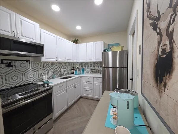 a kitchen with a refrigerator stove and sink